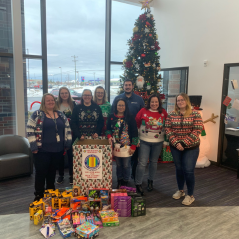 Here is a photo of Alpena team member with the toy drive box.