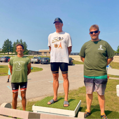 This is a photo from 2024 picturing three winners of the Northland Challenge standing on a podium for first, second, and third place