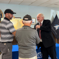 Here is a photo of Jack Eling, Executive VP at Northland, presenting challenge coins to our Veterans Day Luncheon special speakers. 